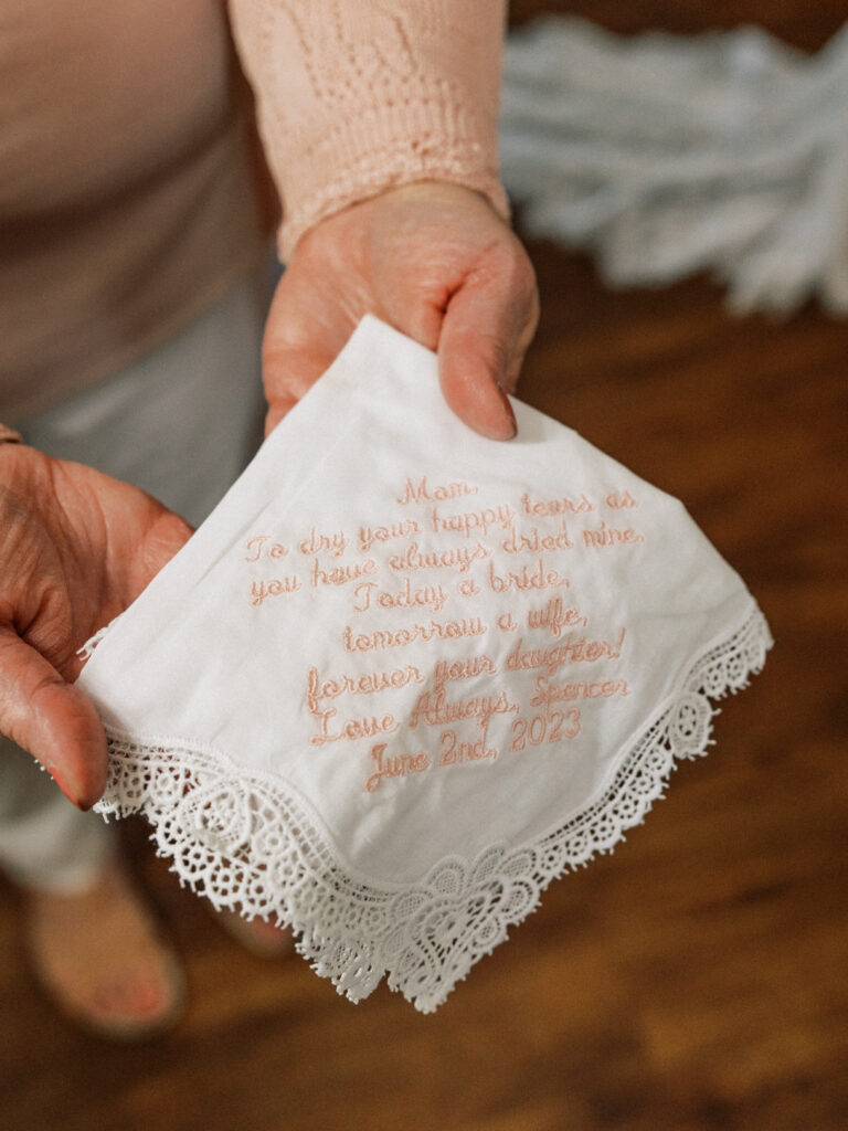 bride giving mom a custom handkerchief 